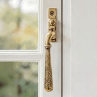 The Left Handed Aged Brass Hammered Espag Window Handle Fitted on a Painted White Window Frame in a Country Home - Digital Illustration The Left Handed Aged Brass Hammered Espag Window Handle Fitted on a Painted White Window Frame in a Country Home - Digital Illustration