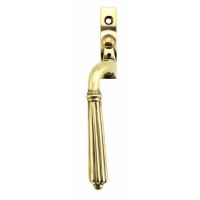 The Left Handed Aged Brass Reeded Georgian Espagnolette Window Handle on a White Background The Left Handed Aged Brass Reeded Georgian Espagnolette Window Handle on a White Background