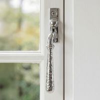 The Right Handed Bright Chrome Hammered Espag Window Handle Mounted on a Classic White Wooden Window Frame - Digital Illustration 