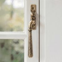 The Left Handed Polished Bronze Hammered Espag Window Handle on a Hand painted White Window Frame - Digital Illustration 