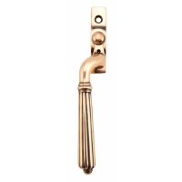 The Left Handed Polished Bronze Reeded Georgian Espagnolette Window Handle on a White Background The Left Handed Polished Bronze Reeded Georgian Espagnolette Window Handle on a White Background
