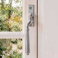 The Left Handed Polished Chrome Reeded Georgian Espagnolette Window Handle on a White Wooden Window Frame with Garden in the Background - Digital Illustration .jpg The Left Handed Polished Chrome Reeded Georgian Espagnolette Window Handle on a White Wooden Window Frame with Garden in the Background - Digital Illustration .jpg