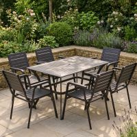 The Linea 6-Seater Outdoor Garden Dining Set in Black in a Sunny Low Walled Garden Surrounded by Plants