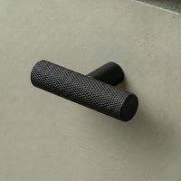The Matt Black "Astor" Knurled Industrial T-Bar Cabinet Handle Mounted on a light Green Kitchen Cupboard Drawer - Digital Illustration The Matt Black "Astor" Knurled Industrial T-Bar Cabinet Handle Mounted on a light Green Kitchen Cupboard Drawer - Digital Illustration
