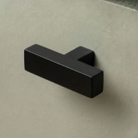 The Aged Brass "Kodiak" Heavyweight Block T-Bar Cabinet Handle Mounted on a Dark Blue Kitchen Cupboard Drawer - Digital Illustration 