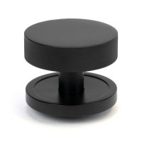 The Matt Black Knurled Centre Door Knob on a Plain Rose Shown Upright on a White Background The Matt Black Knurled Centre Door Knob on a Plain Rose Shown Upright on a White Background
