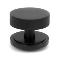 The Matt Black Knurled Centre Door Knob on an Art Deco Rose Shown Upright on a White Background The Matt Black Knurled Centre Door Knob on an Art Deco Rose Shown Upright on a White Background