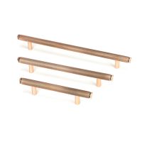 The Medium Knurled Cabinet Pull Handle in Polished Bronze Shown Alongside Other Sizes on a White Background