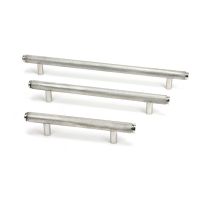 The Medium Knurled Cabinet Pull Handle in Satin Stainless Steel Shown Alongside Other Sizes on a White Background The Medium Knurled Cabinet Pull Handle in Satin Stainless Steel Shown Alongside Other Sizes on a White Background