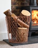 The Medium Rose Gold Wire Log Basket filled with Logs in a Modern White Living Room - Digital Illustration