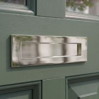The Modern 10 Inch Front Door Letter Plate with Contemporary Minimalist Flap in Polished Nickel on a Moss Green Coloured Front Door Made from Timber - Digital Illustration