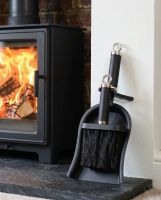 The Modern Black and Chrome Brush and Pan Set next to a Cream Coloured Fireplace with a Log Burner Stove - Digital Illustration  