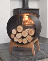 The Modern "Henlow" Contemporary Log Holder in front of a lit Log Burner Stove in a Minimalist Home - Digital Illustration 