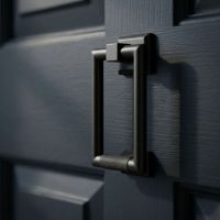 The Modern Knurled Rectangular Door Knocker  in Aged Bronze Fitted onto a Front Door thats been Painted Blue - Digital Illustration