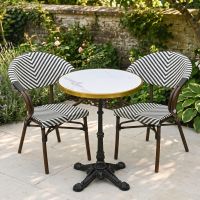 The Monaco Parisian Bistro Set in Black and White in a Sunny Low Walled Garden Surrounded by Plants