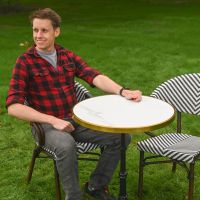 The Monaco Parisian Bistro Set in Black and White With a Man Sat Relaxing at the Table