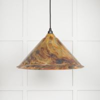 The Nidus Pendant Light in a Burnished Finish on a White Panelled Background with Light on