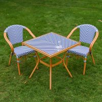 The Nizza Chevron Square Bistro Set in Blue & White Shown from a High Angle on a Lawn