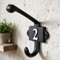 The Number 2 Iron Coat Hook on a Textured White Wall in a Traditional Home - Digital Illustration The Number 2 Iron Coat Hook on a Textured White Wall in a Traditional Home - Digital Illustration