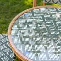 The Orbis Diamond 4-Seater Bistro Dining Set in Green & White Showing a Close up of the Glass Top Table