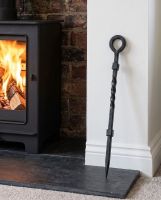 The “Pearson Place” Wrought Iron Fireside Poker Against a Log Basket in a Traditional Living Room - Digital Illustration 
