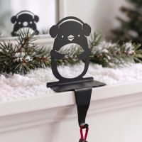 The Penguin with Ear Muffs Stocking Holder on a White Mantelpiece in a Luxury Home - Digital Illustration The Penguin with Ear Muffs Stocking Holder on a White Mantelpiece in a Luxury Home - Digital Illustration