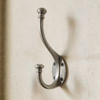 The Pewter Wall Mounted Coat Hook Shown Close up on a Cream Wall - Digital Illustration 