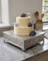 The Polished Aluminium Three Tier Cake Stand Displayed with a Cake on Top - Digital Illustration The Polished Aluminium Three Tier Cake Stand Displayed with a Cake on Top - Digital Illustration