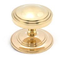 The Polished Brass Art Deco Stepped Centre Door Knob on a White Background The Polished Brass Art Deco Stepped Centre Door Knob on a White Background