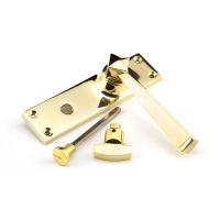 The Polished Brass Geometric Tapered Privacy Suite Bathroom Lever Handles Shown on its Side The Polished Brass Geometric Tapered Privacy Suite Bathroom Lever Handles Shown on its Side