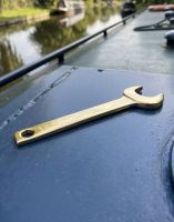 The Polished Brass Marine Spanner Shown Resting on Top of a Canal Boat - Digital Illustration 