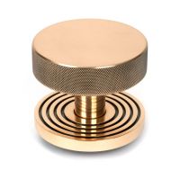 The Polished Bronze Knurled Centre Door Knob on a Beehive Rose Shown Upright on a White Background 