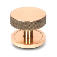 The Polished Bronze Knurled Centre Door Knob on a Plain Rose Shown Upright on a White Background The Polished Bronze Knurled Centre Door Knob on a Plain Rose Shown Upright on a White Background
