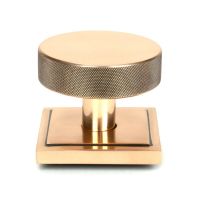 The Polished Bronze Knurled Centre Door Knob on a Square Rose Shown Upright on a White Background The Polished Bronze Knurled Centre Door Knob on a Square Rose Shown Upright on a White Background