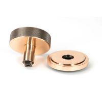 The Polished Bronze Knurled Centre Door Knob on an Art Deco Rose Displayed in Separate Sections on a White Background The Polished Bronze Knurled Centre Door Knob on an Art Deco Rose Displayed in Separate Sections on a White Background