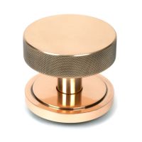 The Polished Bronze Knurled Centre Door Knob on an Art Deco Rose Shown Upright on a White Background The Polished Bronze Knurled Centre Door Knob on an Art Deco Rose Shown Upright on a White Background