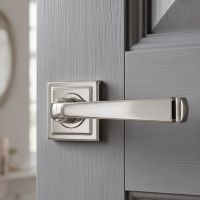 The Polished Chrome Tapered Lever on Square Rose Set on a Light Grey Door in a Cream Living Room Setting - Digital Illustration