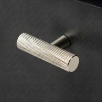 The Matt Black "Astor" Knurled Industrial T-Bar Cabinet Handle Mounted on a light Green Kitchen Cupboard Drawer - Digital Illustration