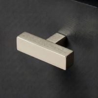 The Polished Nickel "Kodiak" Heavyweight Block T-Bar Cabinet Handle Mounted on a Dark Charcoal Kitchen Cupboard Drawer - Digital Illustration 