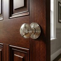 The Polished Nickel Ridged Door Knob Set on a Living Room Door in a Modern Home - Digital Illustration The Polished Nickel Ridged Door Knob Set on a Living Room Door in a Modern Home - Digital Illustration