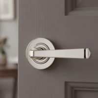 The Polished Nickel Tapered Lever on Plain Rose Set on a Light Grey Timber Door in a modern Home - Digital Illustration 