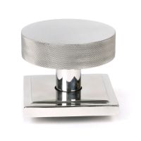 The Polished Stainless Steel Knurled Centre Door Knob on a Square Rose Shown Upright on a White Background 