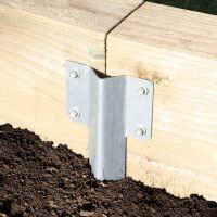 The Pregalvanised Railway Sleeper Straight Inline Spikes - Single in the Ground next to a Railway Sleeper Planter