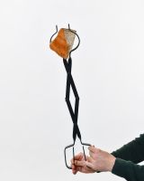 The “Prism” Steel Fire Place Tongs holding log upright