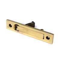 The Retractable Sliding Pocket Door Edge Pull in Aged Brass Shown Lying on its Side