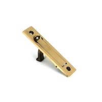 The Retractable Sliding Pocket Door Edge Pull in Aged Brass Shown Stood Upright