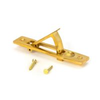 The Retractable Sliding Pocket Door Edge Pull in Polished Brass Shown with Supplied Screws on a White Background