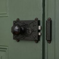 The Reversible "Brackenthorpe" Ornate Black Iron Rim Lock Shown Fitted on a Contemporary Wooden Door - Digital Illustration The Reversible "Brackenthorpe" Ornate Black Iron Rim Lock Shown Fitted on a Contemporary Wooden Door - Digital Illustration