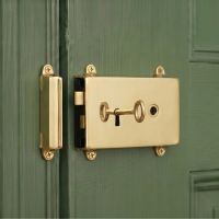 The Reversible "Calabria" Polished Brass Rim Lock Mounted on a Traditional Green Wooden Door - Digital Illustration The Reversible "Calabria" Polished Brass Rim Lock Mounted on a Traditional Green Wooden Door - Digital Illustration
