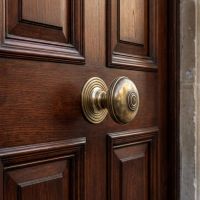 The Ribbed Antique Brass Centre Door Knob Set on a Grand Front Door Entrance - Digital Illustration The Ribbed Antique Brass Centre Door Knob Set on a Grand Front Door Entrance - Digital Illustration